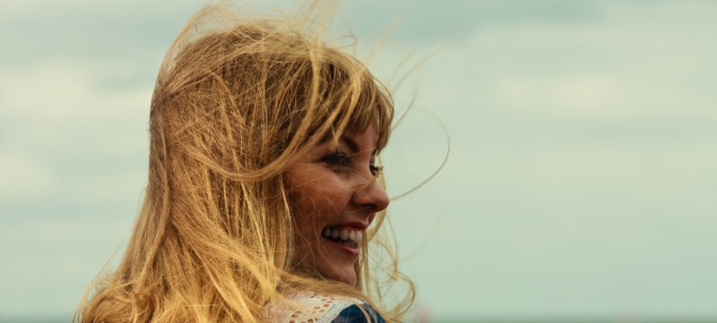 Girl enjoying summer breeze by seaside