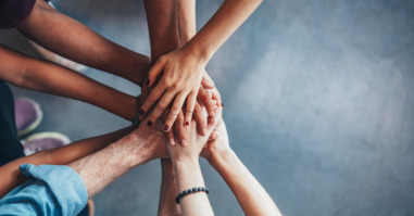 Stack of hands showing unity
