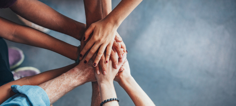 Stack of hands showing unity