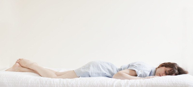 Attractive young woman sleeping in bed