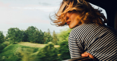 Woman looking at the view from train
