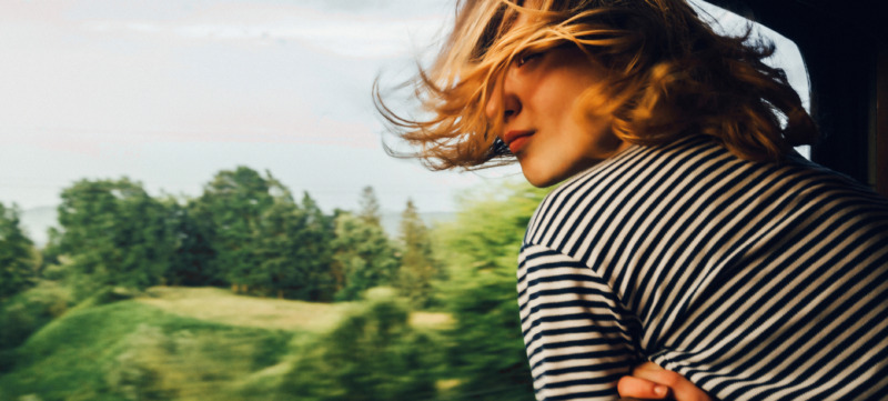 Woman looking at the view from train