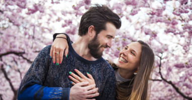 Young couple fall in love under a beautiful cherry tree