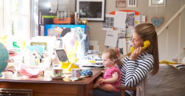 Mother With Daughter Running Small Business From Home Office