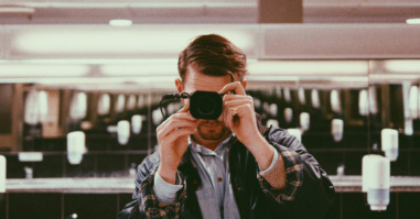 Man Photographing In Public Restroom