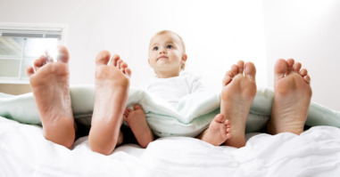 Baby in Bed with Mom and Dad
