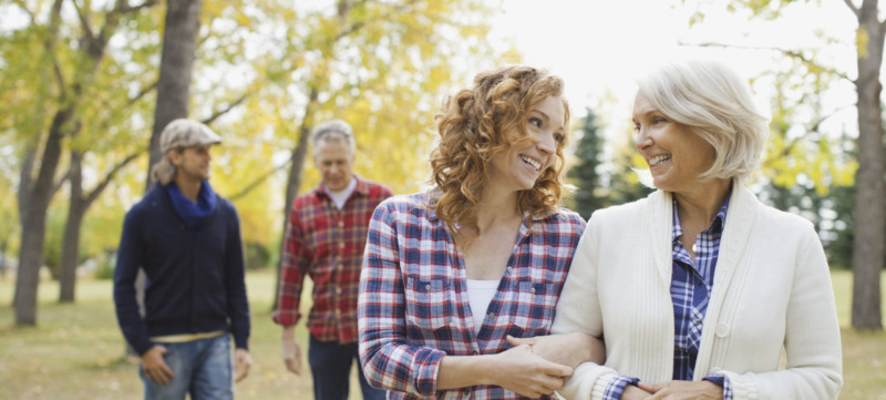 Happy family of four at park during autumn