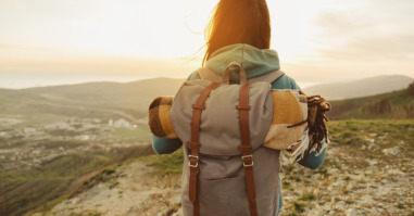 Hiker woman walking outdoor at sunset