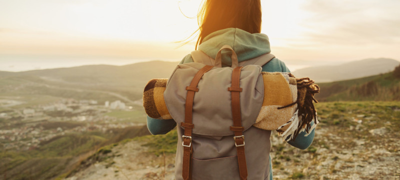 Hiker woman walking outdoor at sunset