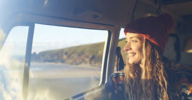 Woman looking out of camper van window.
