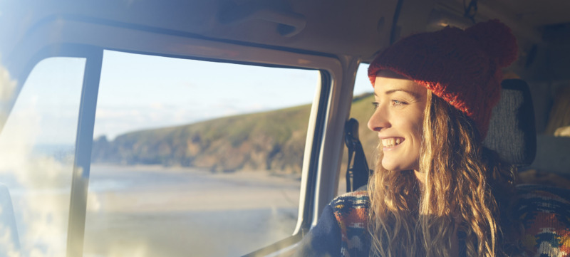 Woman looking out of camper van window.