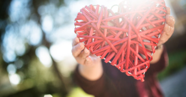 holding an wooden heart for st. valentine