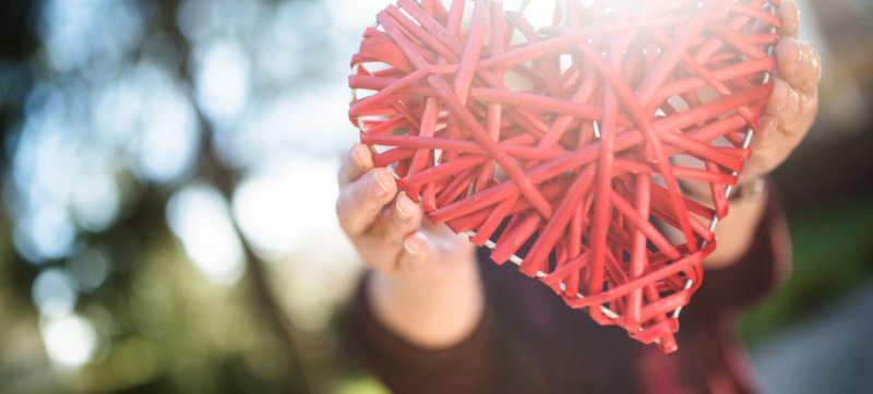 holding an wooden heart for st. valentine