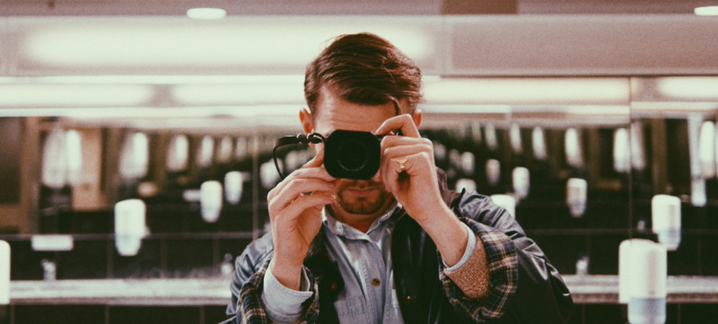 Man Photographing In Public Restroom