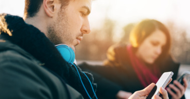 Bored couple sitting separately and surfing the net