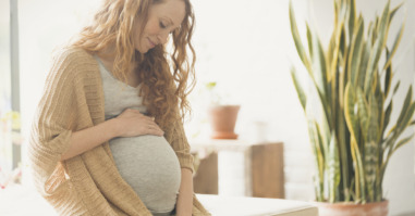 Pregnant woman holding stomach