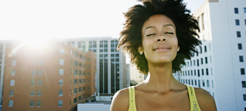Mixed race woman on urban rooftop