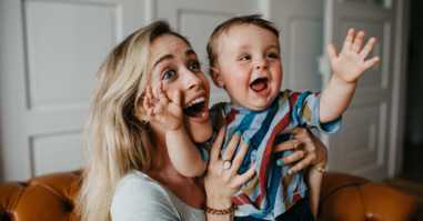 Cheerful Mother With Son At Home