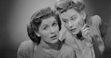 Two women talking indoors