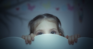 scared little girl in her bed