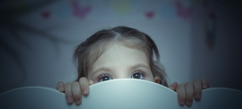 scared little girl in her bed
