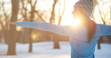 Attractive mixed race woman doing yoga in nature at winter