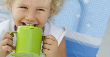 Young child drinking from a cup