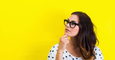 Portrait of young woman, hand on chin in thoughtful pose
