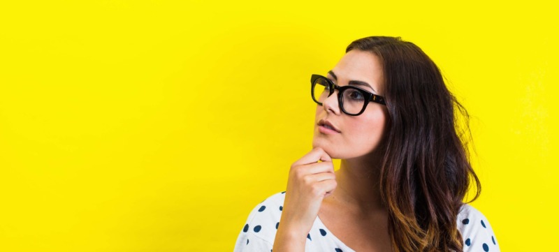 Portrait of young woman, hand on chin in thoughtful pose