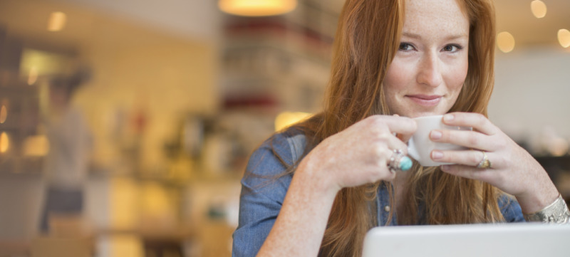 Woman using laptop in cafe