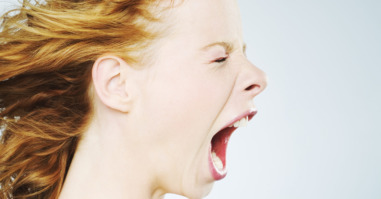 Young woman screaming, close-up, side view