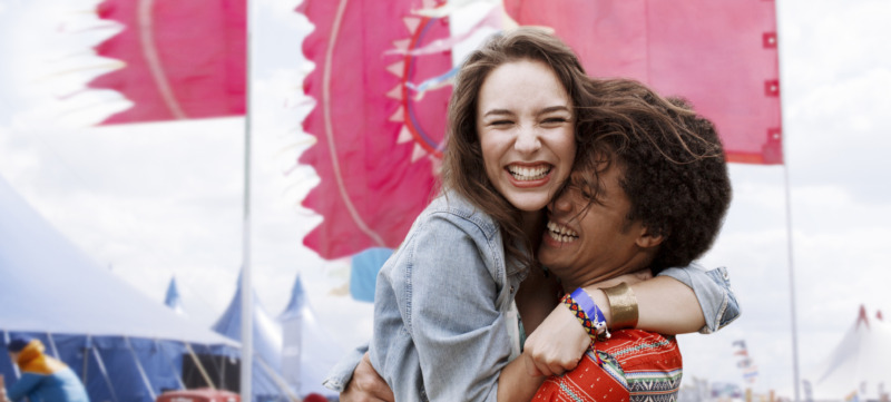 Enthusiastic couple hugging at music festival