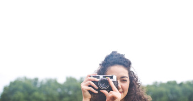 Young woman taking photograph
