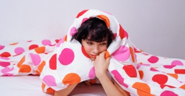 Woman under her duvet