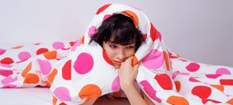 Woman under her duvet