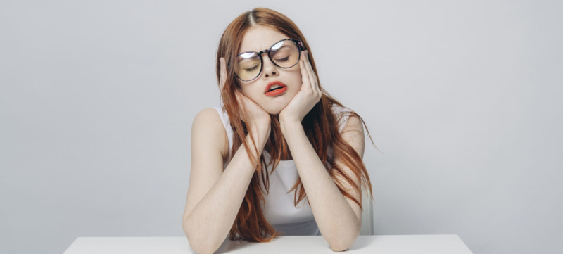 Frustrated Caucasian woman sitting at table