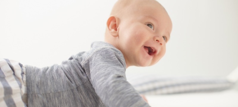 Close up of a happy baby on the bed
