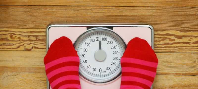Pink striped socks standing on pink scale