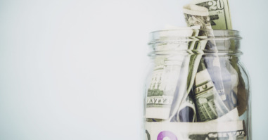 Donation jar overflowing with American money. Fundraising, Savings, Wealth Concepts.