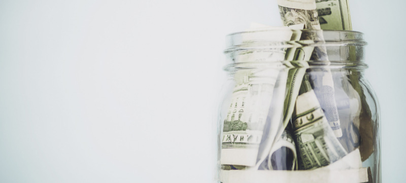 Donation jar overflowing with American money. Fundraising, Savings, Wealth Concepts.