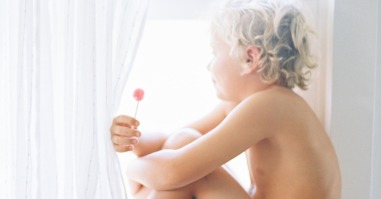 Little Boy In Striped Briefs Sitting In Window With Lollipop