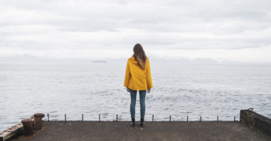 Iceland, woman standing at the sea