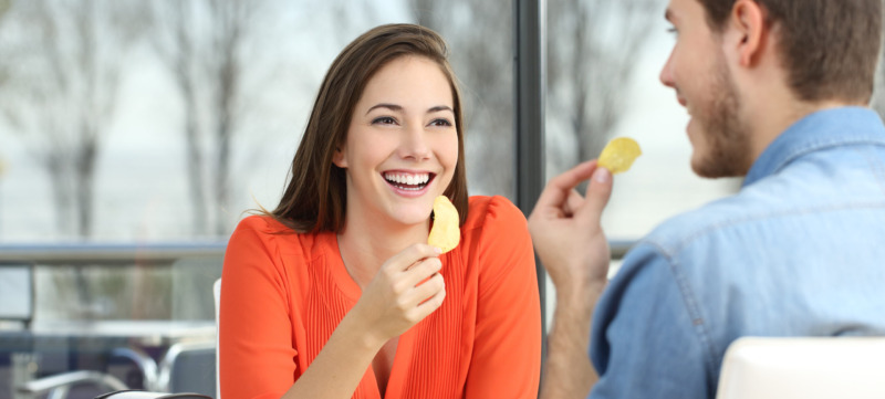 Couple talking and eating chip potatoes