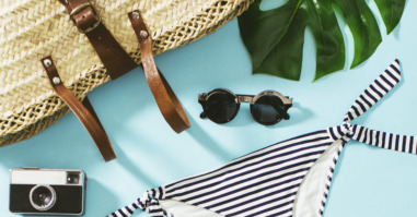 Women Summer Essentials On Blue Background.