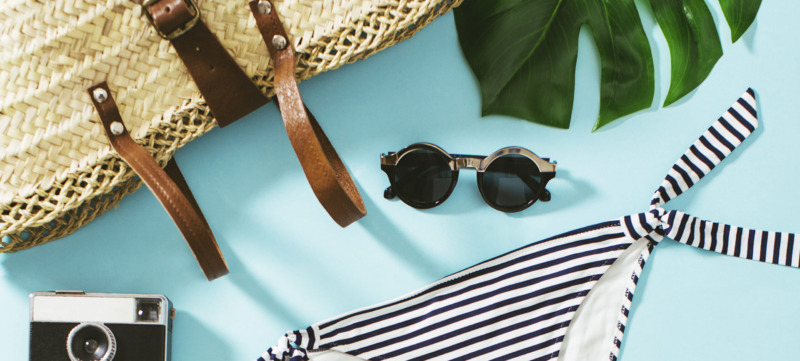 Women Summer Essentials On Blue Background.