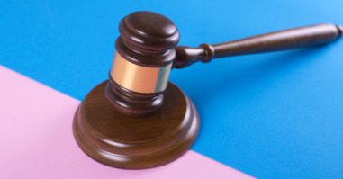 Judge gavel or auction on pink and blue background. Justice and auction.