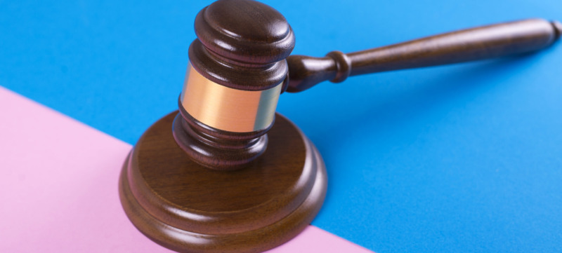Judge gavel or auction on pink and blue background. Justice and auction.