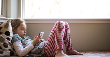 Girl relaxing and looking at smartphone