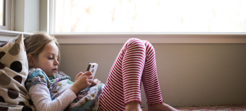 Girl relaxing and looking at smartphone