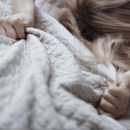 Passionate woman gapping bed linen